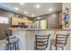 Kitchen bar with seating, stainless steel appliances, and ample counter space, ideal for casual dining and entertaining guests at 44158 W Cypress Ln, Maricopa, AZ 85138