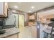 The kitchenette includes a gas stovetop, stainless steel appliances, and a pass-through to the living area, combining functionality and style at 44158 W Cypress Ln, Maricopa, AZ 85138