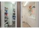 Functional laundry room with a washer, dryer, pantry shelving, and ample storage space, designed for efficient household tasks at 44158 W Cypress Ln, Maricopa, AZ 85138