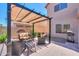 Relaxing covered patio with comfortable seating and stylish decor in a private backyard at 44158 W Cypress Ln, Maricopa, AZ 85138