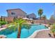 Beautiful backyard pool area with palm trees, lounge chairs, and a clear blue pool at 44158 W Cypress Ln, Maricopa, AZ 85138