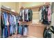 Neatly organized walk-in closet boasts ample storage with rods and shelves for clothing and accessories at 44158 W Cypress Ln, Maricopa, AZ 85138