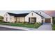 Single-Gathering home featuring manicured lawn, dark trim windows, and a paved driveway to a two-car garage at 5941 E Lafayette Blvd, Phoenix, AZ 85018