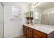 Bright bathroom with a long vanity, large mirror, and modern fixtures at 626 W Catclaw St, Gilbert, AZ 85233