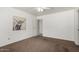 Clean bedroom with plush carpet, a ceiling fan, and a modern painting at 626 W Catclaw St, Gilbert, AZ 85233