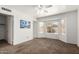 Bright bedroom features plush carpet, a ceiling fan, and large bay windows with a view of the backyard at 626 W Catclaw St, Gilbert, AZ 85233