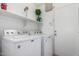 A laundry room with a washer and dryer, shelf, and entry door at 626 W Catclaw St, Gilbert, AZ 85233