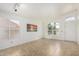 Bright living room featuring neutral tile flooring and plenty of natural light from large windows at 626 W Catclaw St, Gilbert, AZ 85233