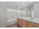 Bathroom with a tub and a double sink vanity and neutral colors throughout at 708 E Mule Train Trl, San Tan Valley, AZ 85143