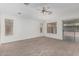 Bright bedroom features neutral carpet, ceiling fan, and large windows for natural light at 708 E Mule Train Trl, San Tan Valley, AZ 85143