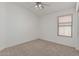 Bedroom featuring a ceiling fan and a window with blinds at 708 E Mule Train Trl, San Tan Valley, AZ 85143