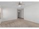 Bright bedroom with neutral carpet, ceiling fan, and neutral walls at 708 E Mule Train Trl, San Tan Valley, AZ 85143