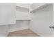 Walk-in closet featuring built in shelves, and neutral carpet at 708 E Mule Train Trl, San Tan Valley, AZ 85143