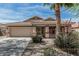 Charming single-story home featuring a tile roof, desert landscaping, and a two-car garage at 708 E Mule Train Trl, San Tan Valley, AZ 85143