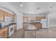 Kitchen with an island, tile flooring and stainless-steel appliances at 708 E Mule Train Trl, San Tan Valley, AZ 85143