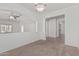 Open-concept space with neutral walls, plush carpeting, and an open entryway at 708 E Mule Train Trl, San Tan Valley, AZ 85143