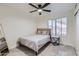 Serene bedroom featuring a ceiling fan, a cozy bed, and a window that offers plenty of natural light at 7239 E Madero Ave, Mesa, AZ 85209