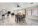 Bright dining area features a modern ceiling fan and stylish tile floors, seamlessly connecting to the open kitchen at 7239 E Madero Ave, Mesa, AZ 85209