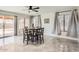 Bright dining area features a modern ceiling fan, stylish tile floors, and sliding glass doors for seamless indoor-outdoor living at 7239 E Madero Ave, Mesa, AZ 85209