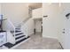 Grand foyer with staircase, high ceilings, and sleek tile flooring for a bright and welcoming entrance at 7239 E Madero Ave, Mesa, AZ 85209