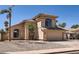 Charming home featuring a two-car garage, desert landscaping, and a classic Mediterranean-style tiled roof at 7239 E Madero Ave, Mesa, AZ 85209