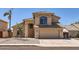 Inviting home exterior featuring a two-car garage, desert landscaping, and a covered entryway at 7239 E Madero Ave, Mesa, AZ 85209