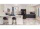 Well-lit kitchen with a breakfast bar, stainless steel appliances, and stylish two-tone cabinetry at 7239 E Madero Ave, Mesa, AZ 85209