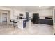 Spacious kitchen featuring a breakfast bar, stainless steel appliances, and contrasting cabinet colors at 7239 E Madero Ave, Mesa, AZ 85209
