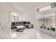 Stylish living room featuring marble floors, a comfortable sectional sofa, and ample sunlight at 7239 E Madero Ave, Mesa, AZ 85209