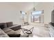 Cozy living room featuring a gray sectional sofa, marble floors, and an airy, open layout at 7239 E Madero Ave, Mesa, AZ 85209
