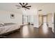 Bright main bedroom featuring vaulted ceiling, ceiling fan, a big bed and a doorway to a baby room at 7239 E Madero Ave, Mesa, AZ 85209