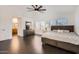 Spacious main bedroom features a large bed, dresser, and ample natural light from the big windows at 7239 E Madero Ave, Mesa, AZ 85209