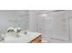 Bright bathroom with a double sink vanity, white countertops, and a shower over tub at 7318 W St Charles Ave, Laveen, AZ 85339