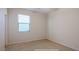 Clean and basic room ready for personalization with carpet and a large window at 7318 W St Charles Ave, Laveen, AZ 85339