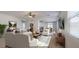 Open-concept living area with stylish furniture, neutral colors, and a view of the dining space at 7318 W St Charles Ave, Laveen, AZ 85339