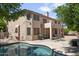 Backyard featuring a swimming pool, covered patio, built-in BBQ area, and mature landscaping at 7340 W Bronco Trl, Peoria, AZ 85383