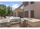 Backyard with a built-in BBQ, patio area, lush greenery, and plenty of room for outdoor activities at 7340 W Bronco Trl, Peoria, AZ 85383