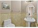 Cozy half-bathroom featuring a toilet, sink and small mirror at 7340 W Bronco Trl, Peoria, AZ 85383