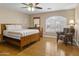 Cozy bedroom featuring hardwood floors, natural light and an accent chair at 7340 W Bronco Trl, Peoria, AZ 85383