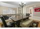 Spacious dining area features chandelier lighting and seating for four at 7340 W Bronco Trl, Peoria, AZ 85383
