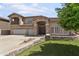 A beautiful two-story stucco home with a three-car garage and stone facade at 7340 W Bronco Trl, Peoria, AZ 85383