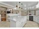 Bright kitchen with an island and white cabinetry, along with tile flooring at 7340 W Bronco Trl, Peoria, AZ 85383