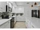 A bright kitchen features white cabinets, granite countertops, and stainless steel appliances at 7340 W Bronco Trl, Peoria, AZ 85383