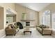 Open-concept living room boasts high ceilings, natural light, and a fireplace at 7340 W Bronco Trl, Peoria, AZ 85383