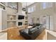 Bright living room featuring a cozy fireplace, large sectional, and two-story ceilings at 7340 W Bronco Trl, Peoria, AZ 85383