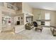 The living room boasts high ceilings, a fireplace, and travertine tile flooring at 7340 W Bronco Trl, Peoria, AZ 85383