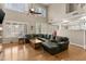 Large living room with a sectional couch, wood floors, and many bright windows at 7340 W Bronco Trl, Peoria, AZ 85383