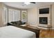 Bright main bedroom featuring large windows, a fireplace, and a cozy seating area at 7340 W Bronco Trl, Peoria, AZ 85383