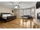 Spacious main bedroom with a fireplace, seating area and a ceiling fan at 7340 W Bronco Trl, Peoria, AZ 85383