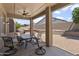 Covered patio featuring tile flooring, ceiling fan, and outdoor furniture with a view of the backyard at 7340 W Bronco Trl, Peoria, AZ 85383
